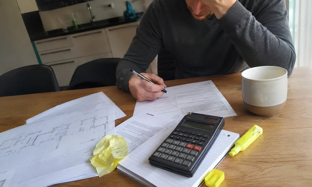 Fort Worth Second Chance Team lease review - printed lease pages, calculator, and settlement letter on a kitchen table
